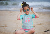 T-shirt Maillot de bain bleu et rose anti uv "jardin secret" pour bébé et enfant fille avec protection solaire UPF50+ et motifs cerises